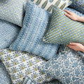 Samode Moss Azure Pillow Cover in pile of block print pillows
