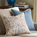 Sanibel Shell Collage Pillow styled on sofa with dusty blue linen pillow