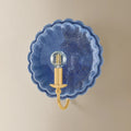 Scalloped Edge Pierce Denim Wall Sconce illuminated on wall