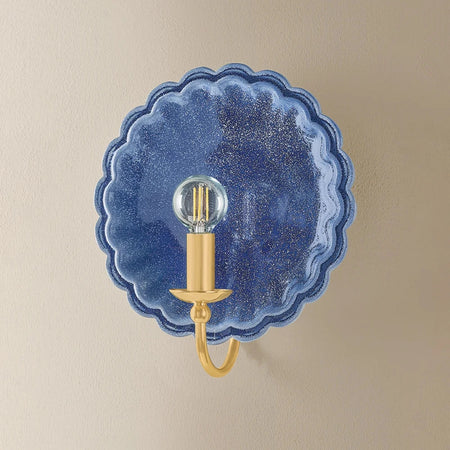 Scalloped Edge Pierce Denim Wall Sconce illuminated on wall