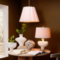 Scalloped White Pendant Light Illuminated in dark room