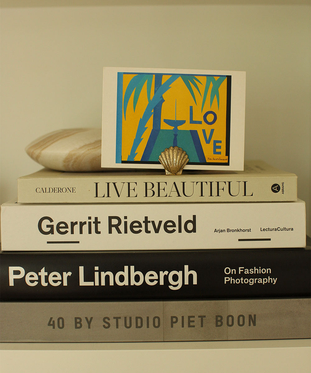 Brass Shell Placecard Holder holding postcard