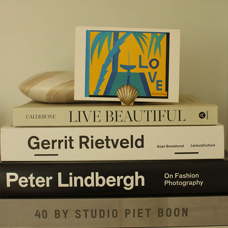 Brass Shell Placecard Holder holding postcard