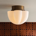 Seabrook Flush Mount - illuminated against wood all