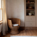 Siena Woven Rattan Barrel Back Lounge Chair in corner
