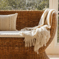 Siena Woven Rattan Settee styled with fringe blanket