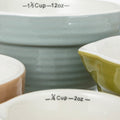 Close-up of ceramic bowls with measurement markings on a white background
