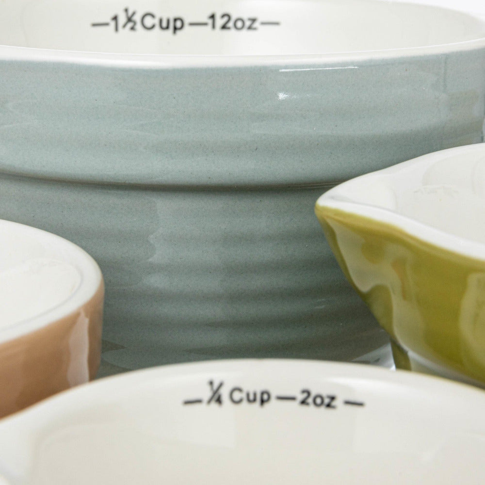 Close-up of ceramic bowls with measurement markings on a white background