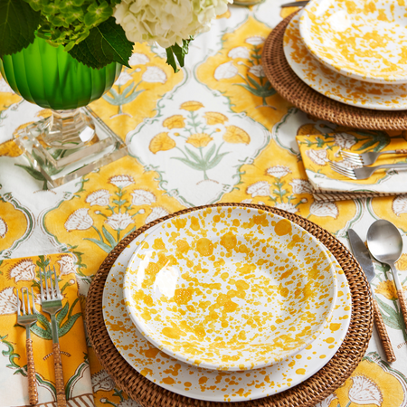 Sunny Days Napkin and Tablecloth styled with yellow splatter dinnerware