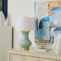 Thiri Pale Celadon Table Lamp Styled on buffet with modern art