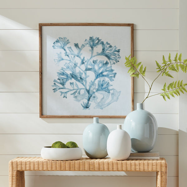 Translucent Blue Coral Framed Print styled above wicker console