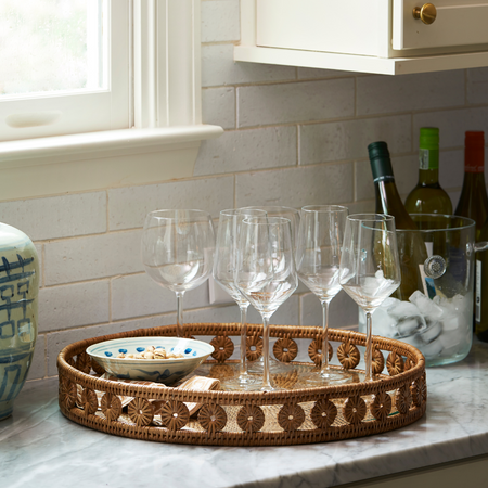 Menton Round Rattan Tray styled with wine glasses