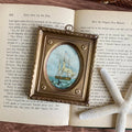 Whaling Ship Print in Antiqued Brass Frame styled with book and starfish