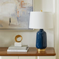 Carolyn Navy Lamp styled on grasscloth dresser