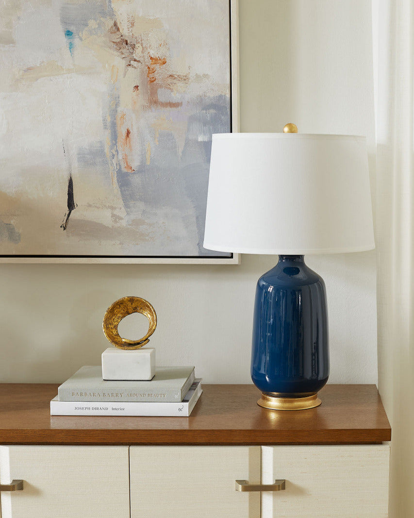 Carolyn Navy Lamp styled on grasscloth dresser