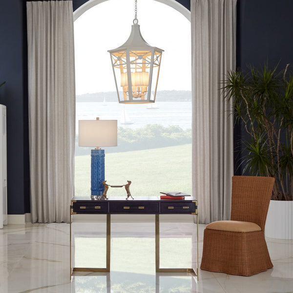 Draped natural wicker chair styled in living room with white lantern