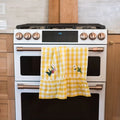 Yellow Ruffle Gingham Dish Towel with embroidered flowers in kitchen