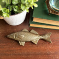 Gold Bass Fish Paper Weight on desk