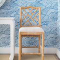 Hayden Natural Counter Stool with blue wallpaper background