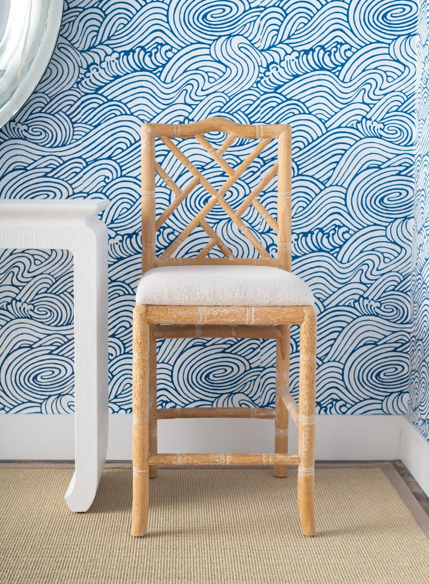 Hayden Natural Counter Stool with blue wallpaper background