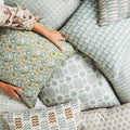 Iznik Moss Celadon Pillow Cover in pile of pillows