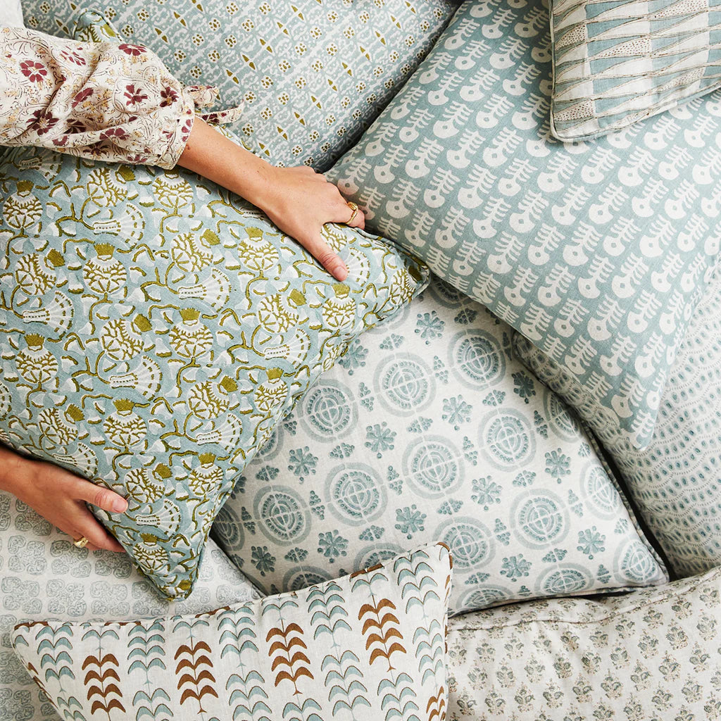 Iznik Moss Celadon Pillow Cover in pile of pillows