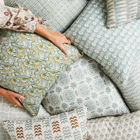 Iznik Moss Celadon Pillow Cover in pile of pillows