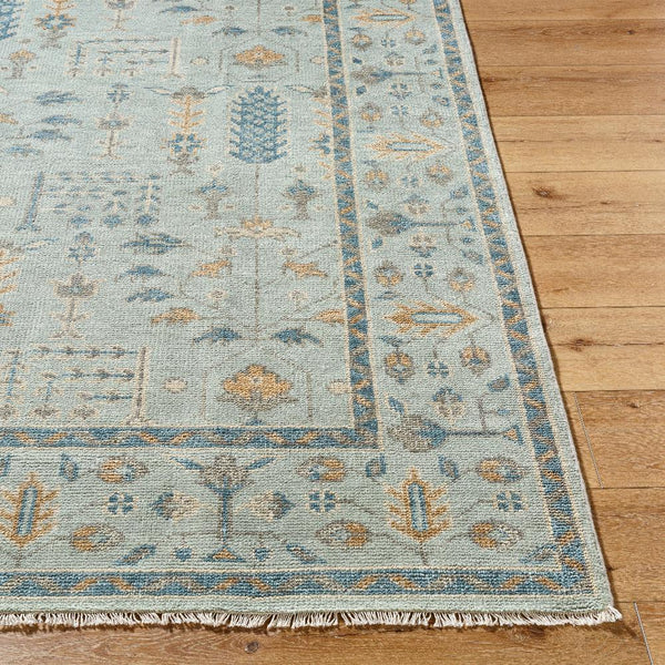 Ranier Wool Blend Blue Rug on wood floor