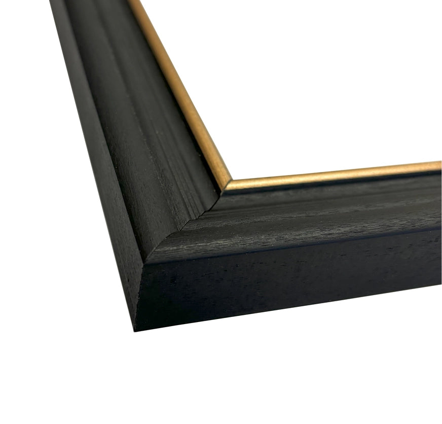 Close-up of a black picture frame with a gold corner detail on a white background