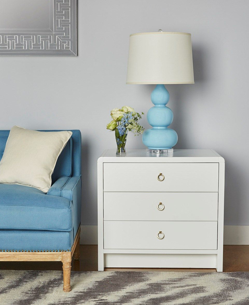 Blaine White Lacquer Three Drawer Side Table Styled with Blue Lamp