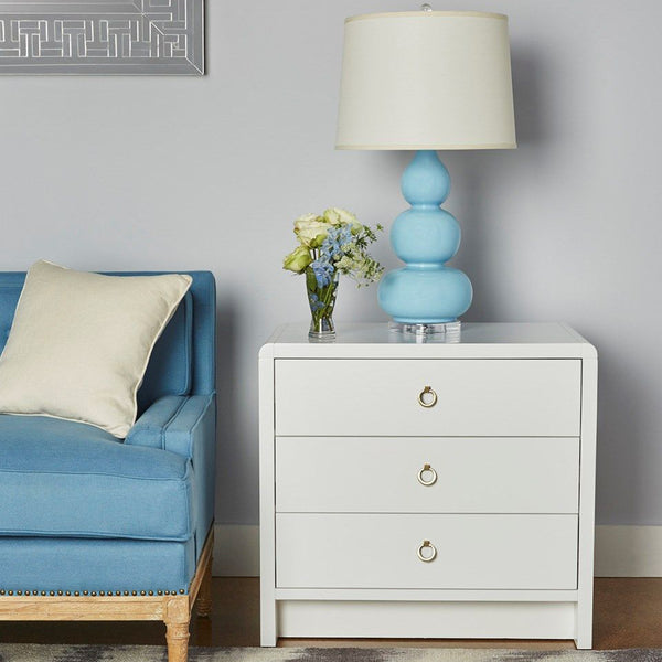 Blaine White Lacquer Three Drawer Side Table Styled with Blue Lamp